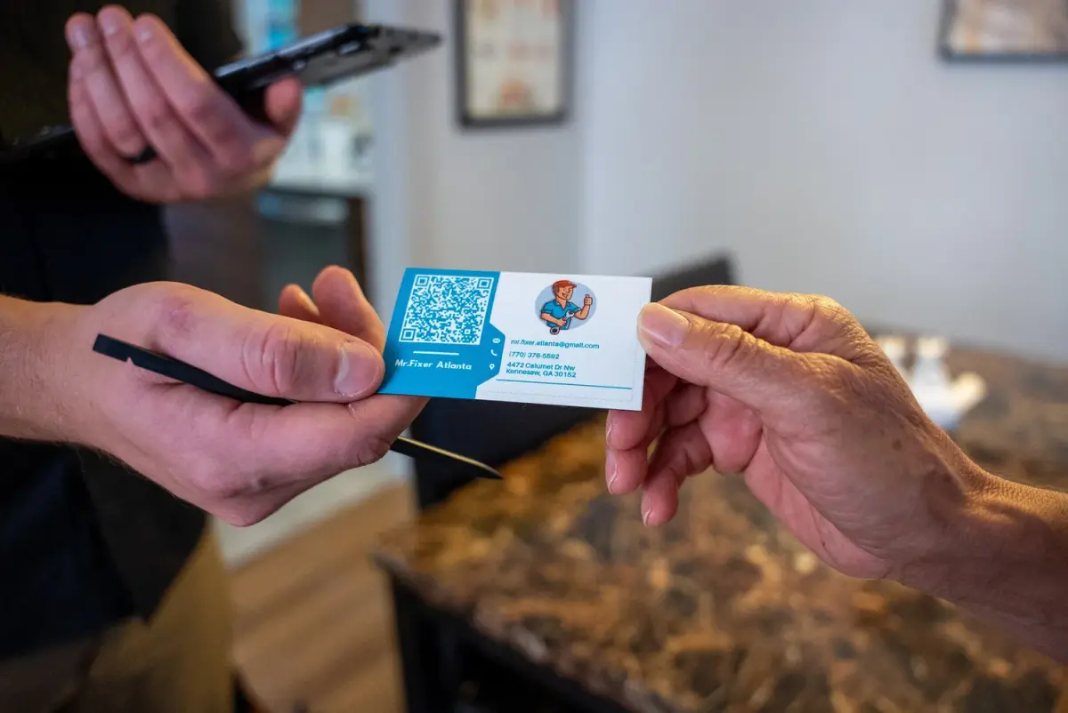 Mr. Fixer technician handing over a business card